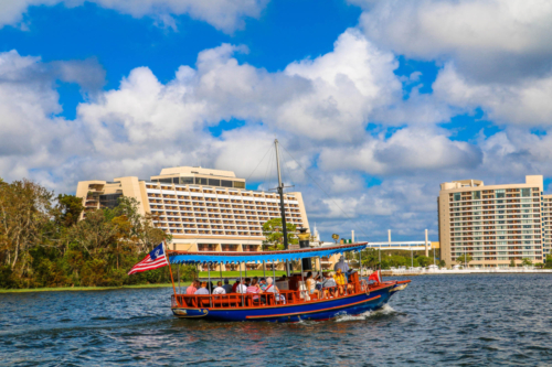 View of Disney Contemporary Resort and DVC Bay Lake Tower from lake with boat